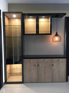 an empty room with cabinets and lights in it