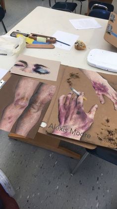 an art project is being displayed on a table in the middle of a class room