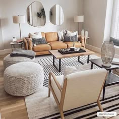 a living room filled with lots of furniture and mirrors on the wall above it's windows