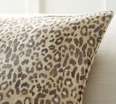 a leopard print pillow sitting on top of a couch