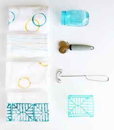 various kitchen utensils and napkins laid out next to each other on a white surface