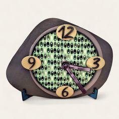 a small clock with numbers on the face