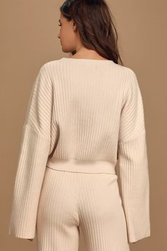 The Lulus Snuggly Style Cream Ribbed Knit Cropped Sweater is on the top of our must-have list! Cozy ribbed knit makes up this cute sweater with a rounded neckline, drop shoulders, and long wide sleeves that offer that perfect slouchy look. Relaxed-fit bodice ends in a cropped hem, perfect to wear with high-waisted bottoms. Pair with the matching pants for a complete look! Fit: This garment fits true to size. Length: Size medium measures 18.5" from shoulder to hem. Bust: Great for any cup size. Waist: Loosely Fitted. Undergarments: May be worn with any standard bra. Fabric: Fabric is very stretchy. Unlined. 55% Viscose, 28% Nylon, 17% Polyester. Hand Wash Cold. Do Not Bleach. Line Dry. Iron Low Heat. Imported. Lulus | Snuggly Style Cream Ribbed Knit Cropped Sweater | Size Small. Knit Cropped Sweater, Long Bell Sleeves, Bell Sleeve Sweater, Cute Sweater, Cream Sweater, Matching Pants, Rounded Neckline, Knit Crop, Cute Sweaters