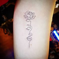 a rose tattoo on the left arm