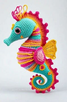 a crocheted sea horse with a crown on it's head and tail