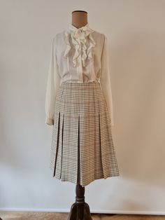 Fletcher Jones Made in Australia Cream with olive and rust checked yarn dyed pleated skirt from the 1980's. Finishing just on below the knee this has a side zip and button fastening and has stitched down pleats to 20cm from high waist point. Permanently pleated all around this is a lovely light winter design in a classic skirt. As these skirts were made to order there is no size, so please see measurements below.  Cream ground with Olive Green, Beige and Rust yarn dyed check. 100% Wool. Made in Vintage Full Pleated Skirt For Fall, Vintage Pleated Skirt For Workwear In Fall, Vintage Pleated Fall Skirt For Workwear, Retro Accordion Pleated Skirt For Fall, Vintage Pleated Skirt For Fall, Vintage Pleated Skirt For Spring Workwear, Vintage Accordion Pleats Skirt For Fall, Fall Vintage Skirt For Workwear, Vintage Workwear Skirt For Fall