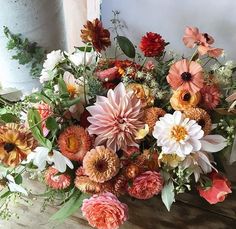 a bunch of flowers that are sitting on a table