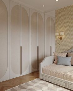 a white day bed sitting in a bedroom next to a wallpapered closet and rug