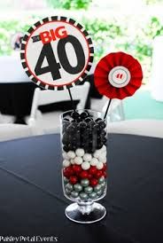 a vase filled with candies and lollipops on top of a table