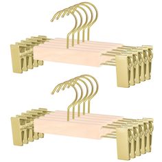 a bunch of gold clothes hangers on a white background