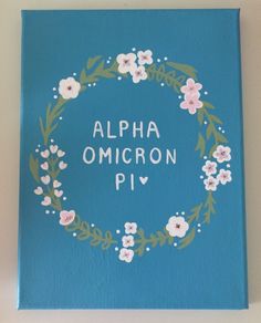 a blue book with white flowers and the words alphabet omgron piv on it