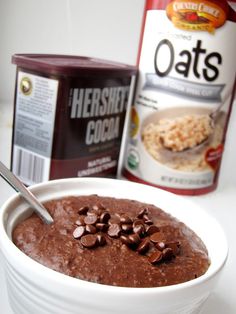 a bowl of chocolate pudding next to a can of oats