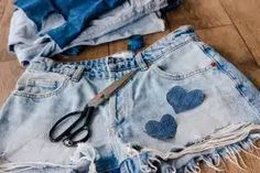 cut off jean shorts with hearts on them, scissors and t - shirt laying on the floor