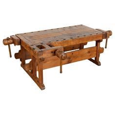 an old wooden table with wheels on it