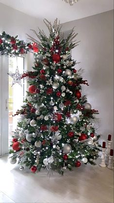 a christmas tree with red and silver ornaments