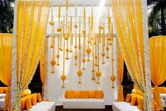 an outdoor ceremony with yellow and white decorations