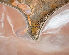 an aerial view of the desert and its surrounding land, including water, sand and trees