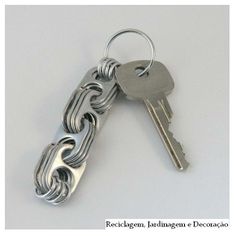 a metal keychain with two keys attached to it, on a white background