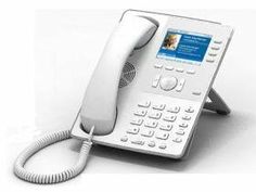 an old style phone is sitting on a white surface with the cord attached to it