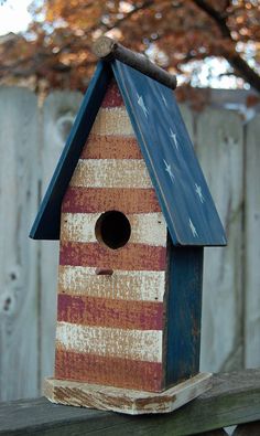 a birdhouse with an american flag painted on it