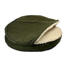 a green dog bed with a white fleece lining on the top and bottom half