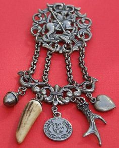 Antique Silver Plated Chatelaine With A Land Munz Medal Or German Coin Dating 1803. The Chatelaine Clip Features A Scene Of A Knight Which May Be George Fighting A Dragon, Having A Hunting Theme, The Attachments Featuring A Puffy Acorn Charm, A Real Animals Tooth, A Silver Deer Antlers And Silver Puffy Heart Charm, With The Lower Part Of The Chatelaine Depicting A Fleur de Lis - Paris, France   c.1880 Hunting Turkey, German Coins, Victorian Accessories, Hunting Supplies, Animal Teeth, Puffy Heart Charms, Turkey Hunting, Hunting Accessories, Steampunk Jewelry