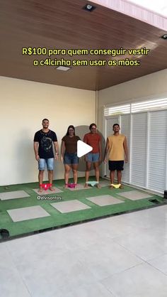 a group of people standing on top of a green mat in front of a doorway