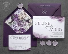 the wedding stationery is purple and white with flowers on it, along with two wax seals