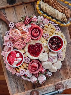 a platter filled with lots of different types of food on top of a wooden table