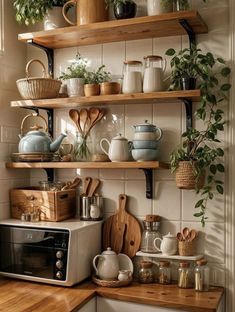 kitchen shelves filled with pots, pans and utensils on top of a wooden counter