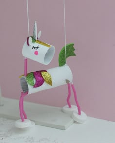 a unicorn made out of toilet paper and some string