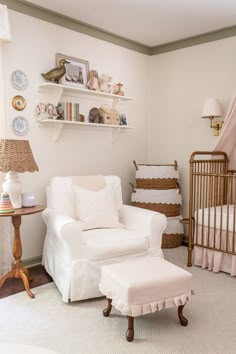 a baby's room with a white chair and crib