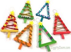 christmas tree ornaments made out of popsicle sticks and colored beads are arranged in a row