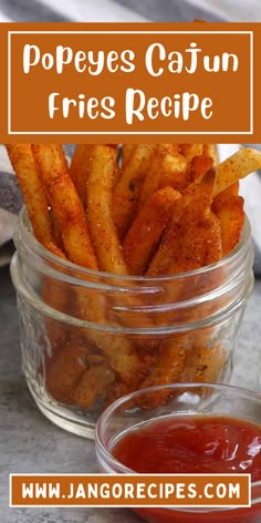 a glass jar filled with fries and ketchup