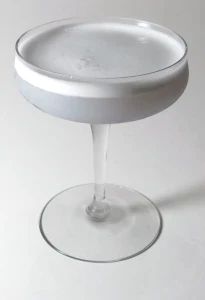 an empty wine glass sitting on top of a table