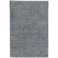 a gray rug with black and white squares on the bottom, in front of a white background