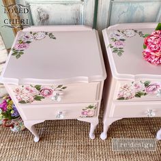 two pink nightstands with flowers painted on the side and one has a flower in it