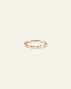 a gold ring with three small dots on the front and one smaller dot on the back