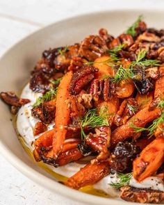 carrots, nuts and yogurt in a bowl with dill on top