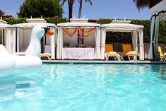 an inflatable ducky floating on top of a pool next to a gazebo