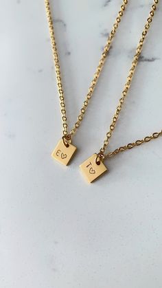 Two (2) personalized square initial charm necklaces made for everyday wear. Each item is specially hand stamped and personalized to offer a variety of meaning and love to your pieces. All materials are made of stainless steel and can be customized with a single horoscope symbol or a maximum of two characters (e.g. letters and numbers). Each charm is 8mm. Please message us if you have specific requests for your order. *Please note that each necklace comes with one stamped (1) charm. If you would like more than one (1) charm on each necklace, please send an inquiry to us on Etsy  How to Order Step 1 - In the first drop down menu, select the colour and length of the first necklace Step 2- In the second drop down menu, select your colour of choice and length for the second necklace Step 3 - Yo Personalized Necklace Silver, Matching Jewelry For Couples, Relationship Necklaces, Cute Dates, Matching Necklaces For Couples, Couple Gift Ideas, Cute Bf, Couples Necklace, Rose Gold Initial