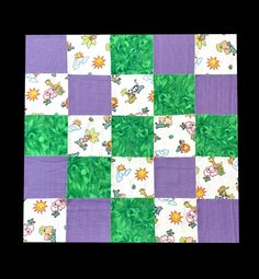 a purple and green patchwork quilt with cartoon characters on the squares in different colors