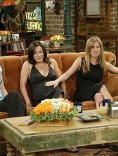 three women sitting on a couch in a living room