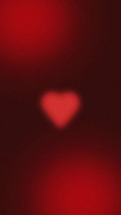 a blurry image of a red heart in the dark