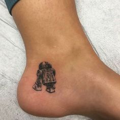 a small tattoo on the foot of a person who is wearing a star wars costume