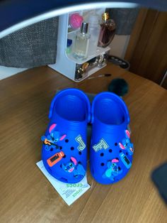 Staring at these till I'm blue in the face 🔵 Customised Stitch X Prime  Glow in the dark initials can be changed upon request  Unisex children size 10. Blue Crocs With Charms, Blue Crocks Shoes, Blue Bling Crocs, Blue Custom Crocs, Dark Blue Crocs, Cookie Monster Slippers, Blue Crocs, Im Blue, Clogs And Mules