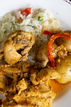 the meal is prepared and ready to be eaten on the plate with rice, peppers, and chicken