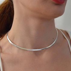 Very good quality sterling silver .925 smooth shiny finish Omega chokers, stylish and trendy. Five different styles to choose from. Choose a desired color and a style by a number from the drop down, SIZES Choker size in flat style 4 mm x 16'' numbers ( 1,2, and 3) Choker size in round style 2 mm x 16'' numbers ( 4 and 5) COLORS Sterling silver. Gold over silver Rose gold color (#4 only) Good gift for: Mother's day. Birthday, Anniversary Graduation Perfect for work & everyday style for the la Herringbone Choker Necklace For Gift, Gift Herringbone Choker Necklace, Snake Chain Necklace Choker For Gift, Trendy Silver Snake Chain Choker, Snake Chain Choker Necklace Perfect For Gifts, Elegant Silver Snake Chain Choker, Gift Snake Chain Choker With Clavicle Chain, Gift Snake Chain Clavicle Choker, Trendy Sterling Silver Choker Gift