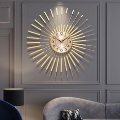 a clock that is on the wall above a couch in a room with grey walls