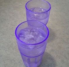 three purple plastic cups filled with ice and water